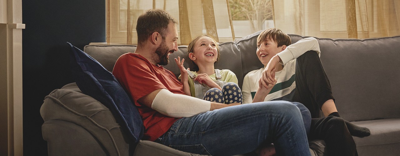 Man and two children on a couch