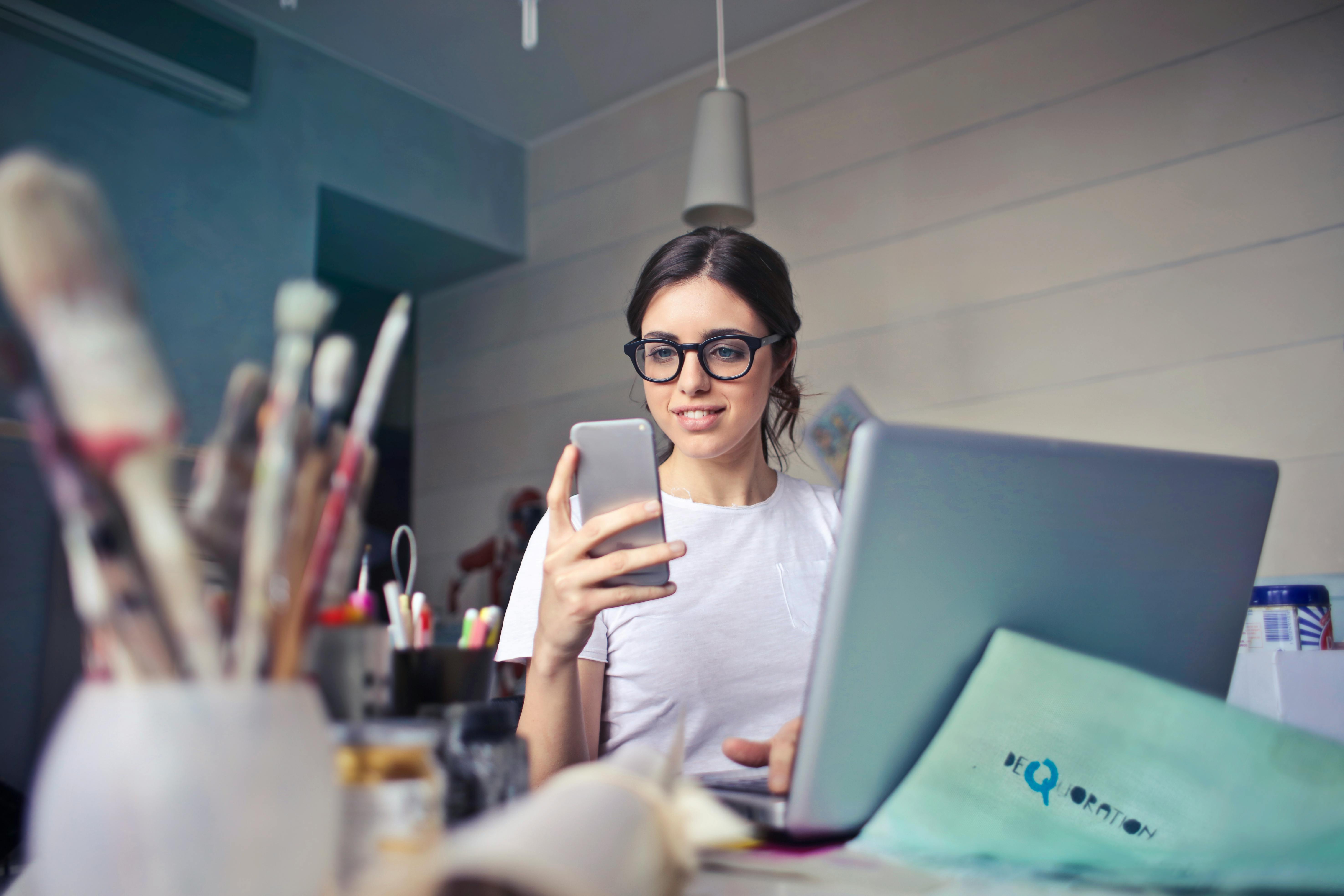 Woman on phone and laptop